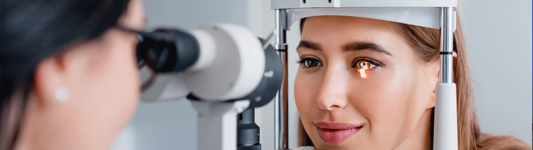 Eye doctor with female patient during an examination in modern clinic